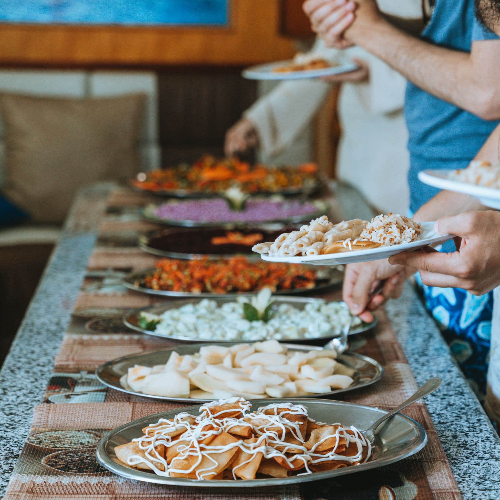 Guests choosing food from the boat buffet between dives