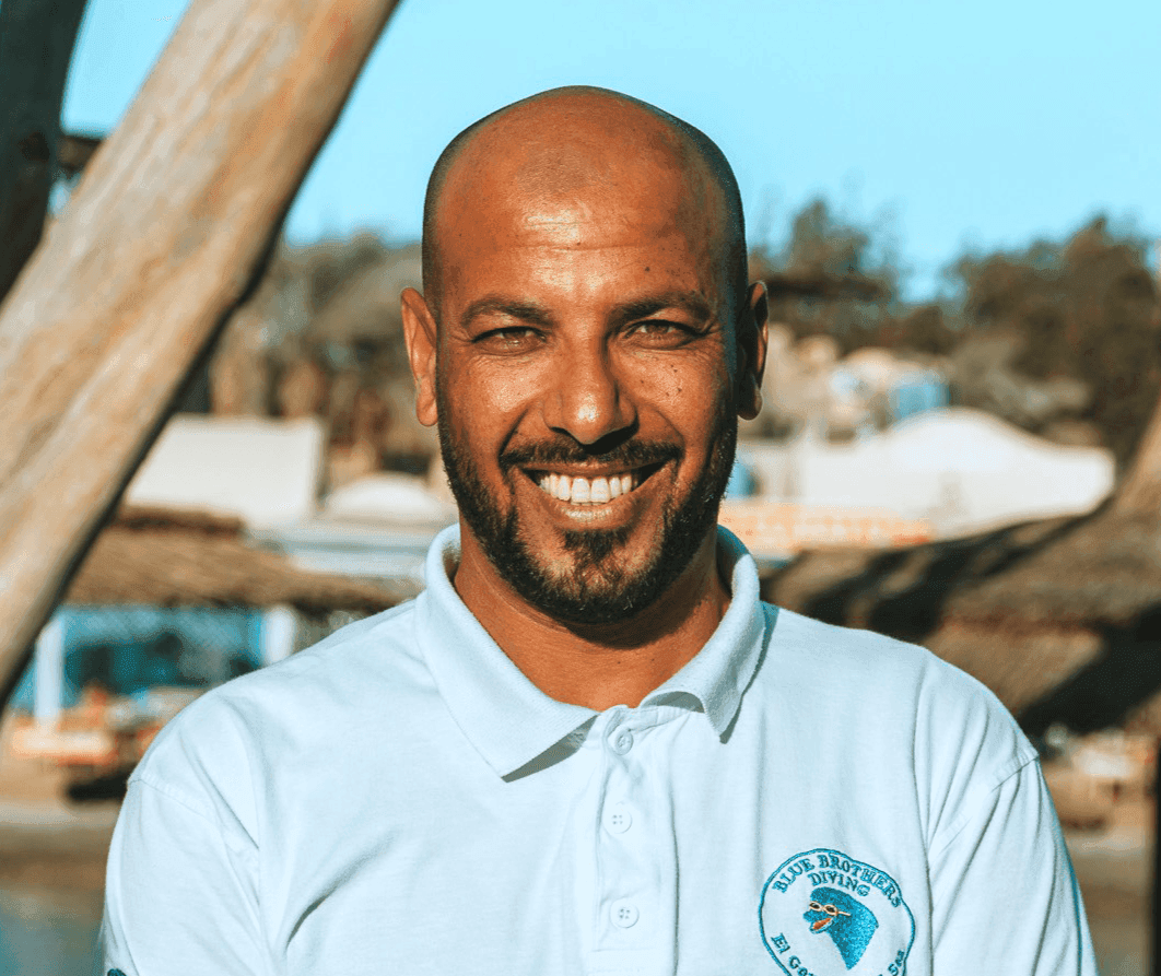 Fahmy from the Blue Brothers Diving team smiling outdoors