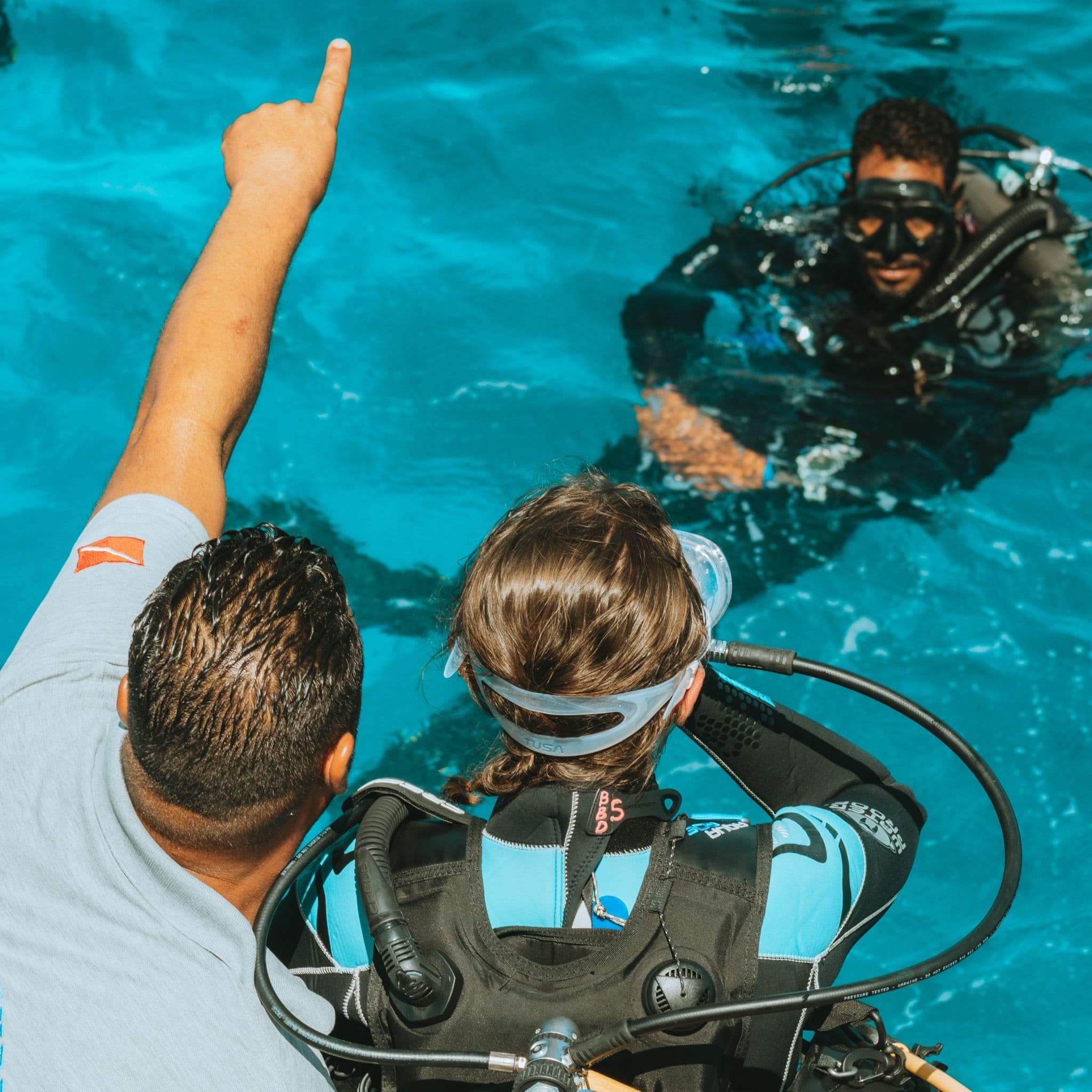 Divemaster trainee assisting a student in the pool