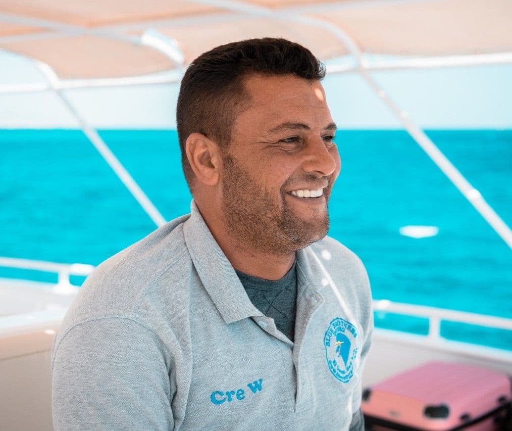 Khamis from the boat crew smiling on board