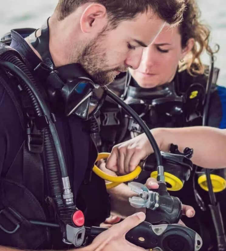 Diver receiving help with scuba equipment before a Red Sea trip