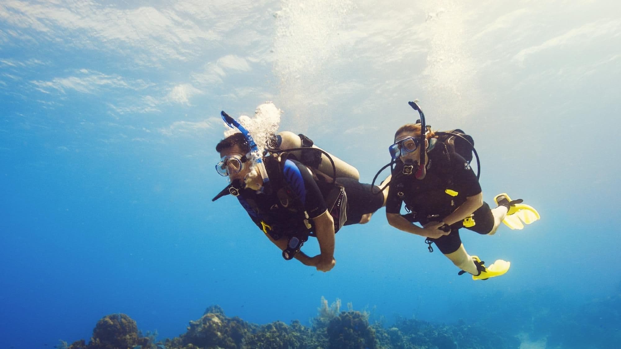 Scuba Diver students swimming in clear Red Sea water