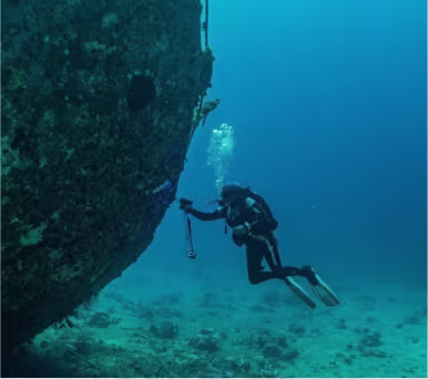 Diver using a reel and line during wreck training